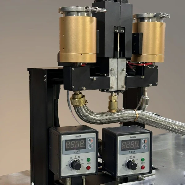 Heated reservoirs and dual-zone temperature controllers on a cartridge filling machine