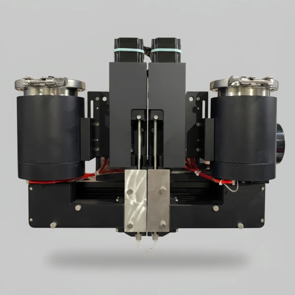 Dual dispensing head of a cartridge filling machine showing the material path from reservoir to nozzle